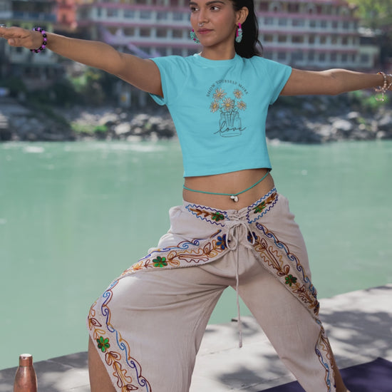 girl wearing FBK graphic crop top doing yoga