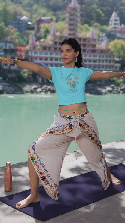 girl wearing FBK graphic crop top doing yoga